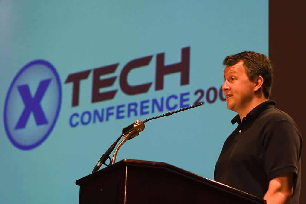 Paul Graham speaking at a podium at the XTech Conference